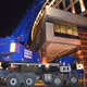 Автокран Liebherr LTF 1060 спускает автомобиль с крыши отеля Lotte в Москве