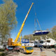 Автокран Liebherr LTM 1350 спускает на воду катера